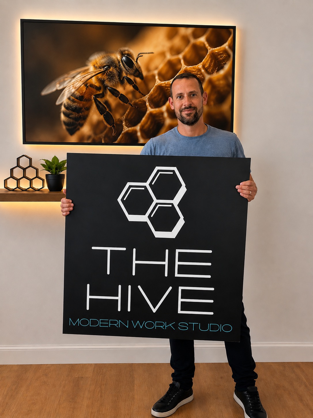 Eric Marterella, Founder of The Hive, holding the company sign
