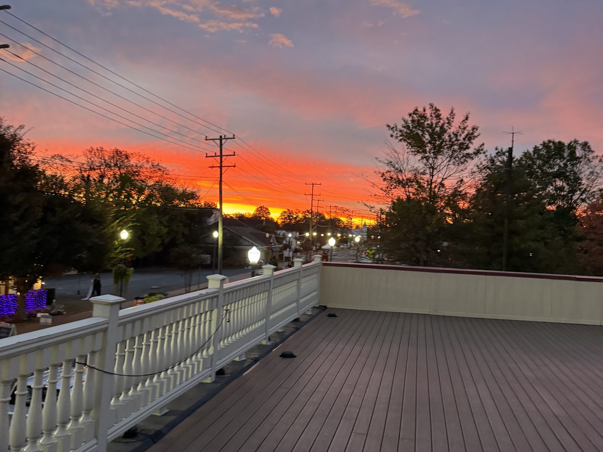 The Hive's rooftop terrace glowing under a vivid golden-hour sunset