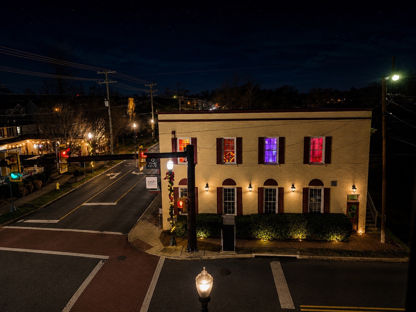 The Hive illuminated at night on its historic corner in downtown Haymarket, Virginia